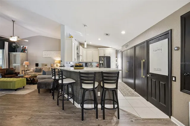 a large kitchen with a table and chairs