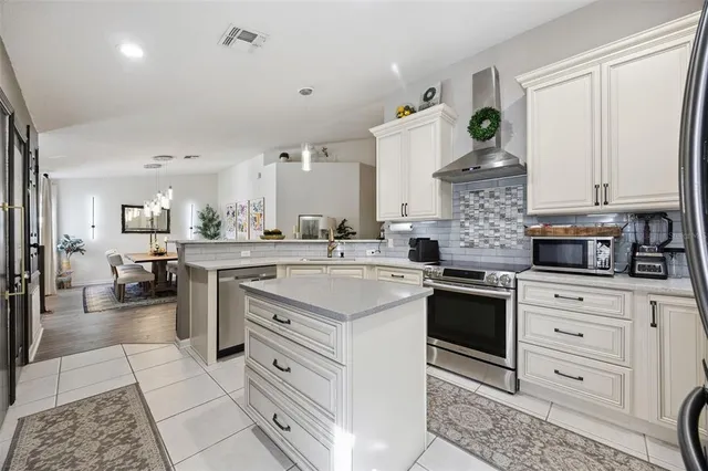 a kitchen with a stove and cabinets