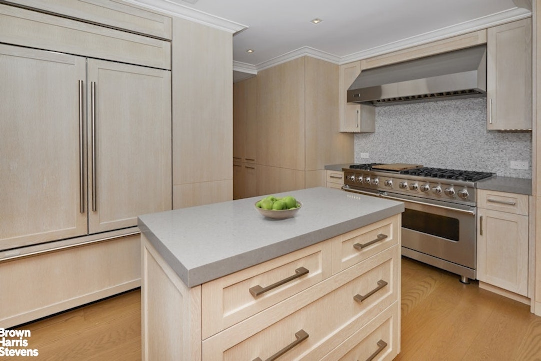 150 East 69th Street, Unit 4M Manhattan, NY 10021 - Photo 14 of 24 a kitchen with a stove and a cabinet