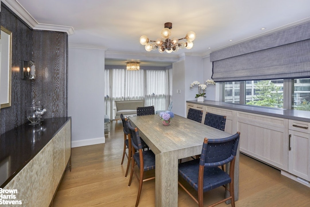 150 East 69th Street, Unit 4M Manhattan, NY 10021 - Photo 15 of 24 a large kitchen with a table and chairs