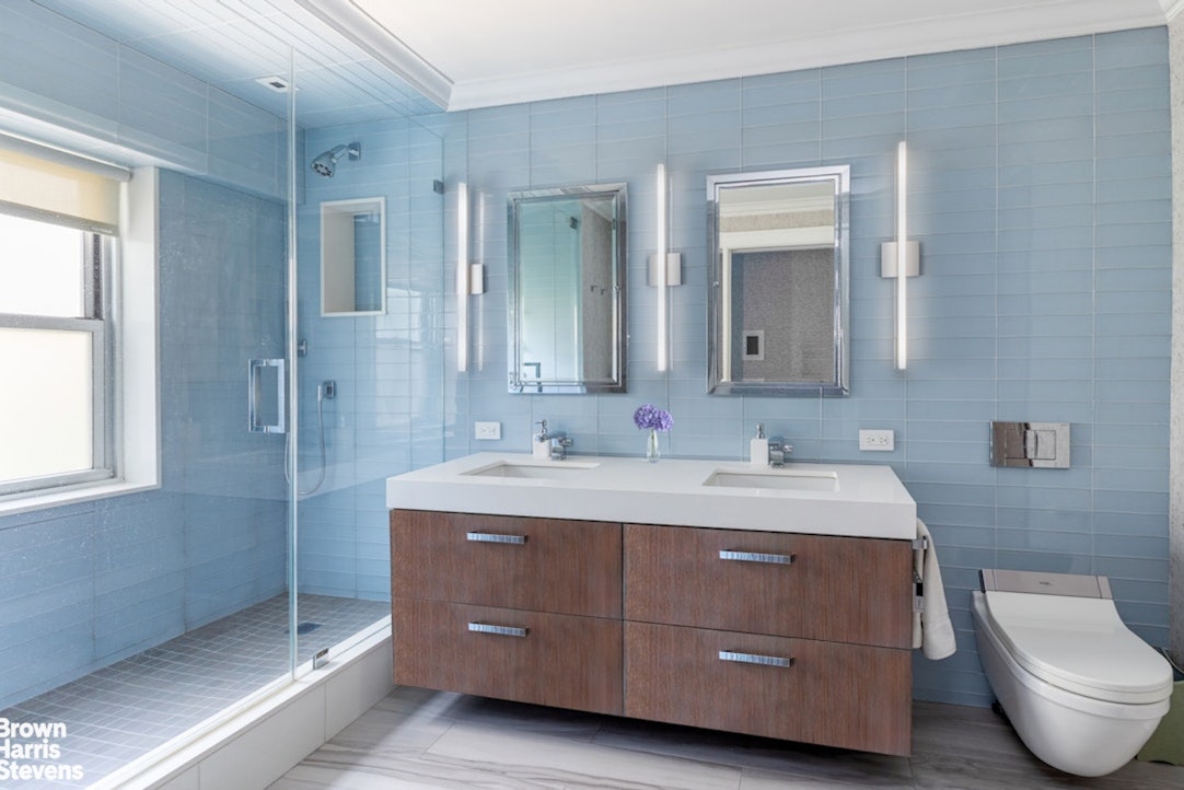 150 East 69th Street, Unit 4M Manhattan, NY 10021 - Photo 17 of 24 a bathroom with a toilet sink and mirror