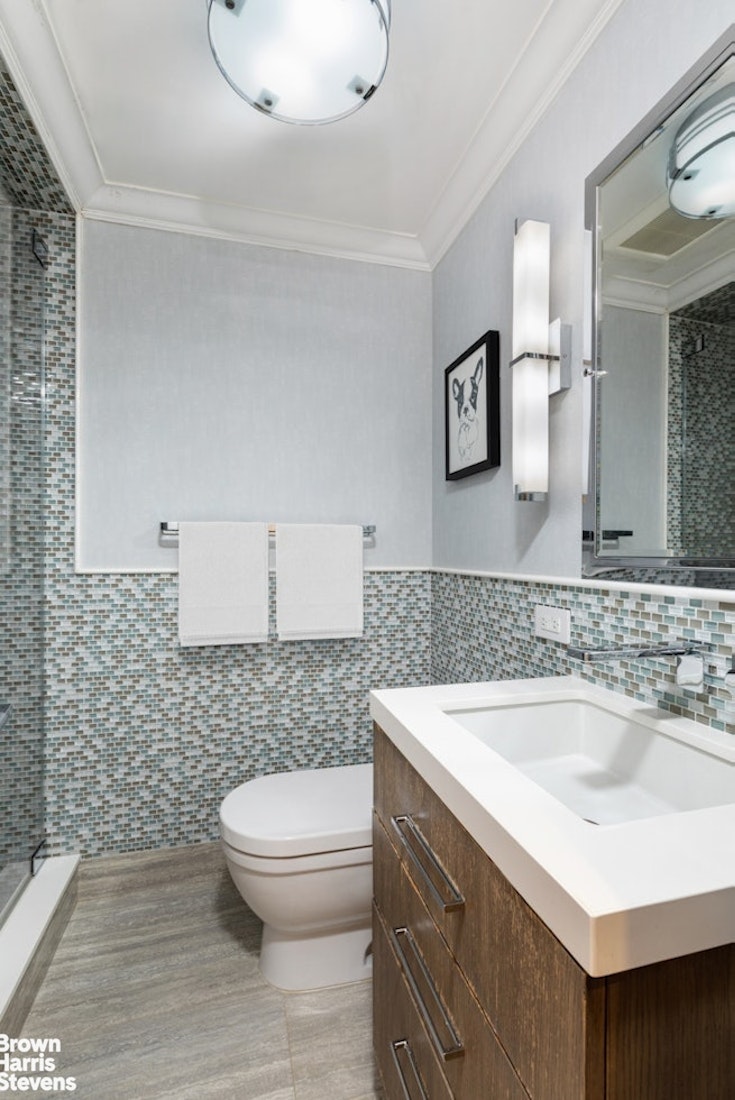 150 East 69th Street, Unit 4M Manhattan, NY 10021 - Photo 23 of 24 a bathroom with a sink a toilet and mirror