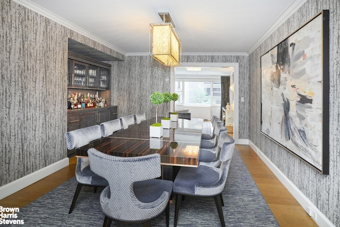 150 East 69th Street, Unit 4M Manhattan, NY 10021 - Photo 4 of 24 a living room with furniture and a large window