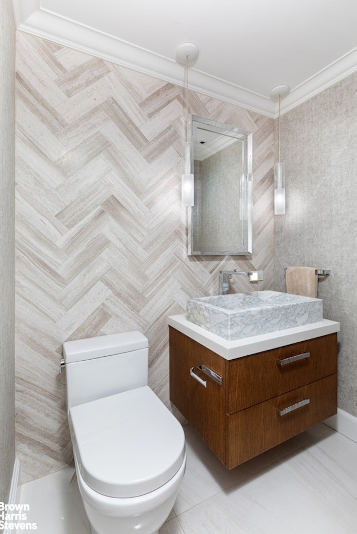 150 East 69th Street, Unit 4M Manhattan, NY 10021 - Photo 8 of 24 a bathroom with a granite countertop toilet sink and mirror