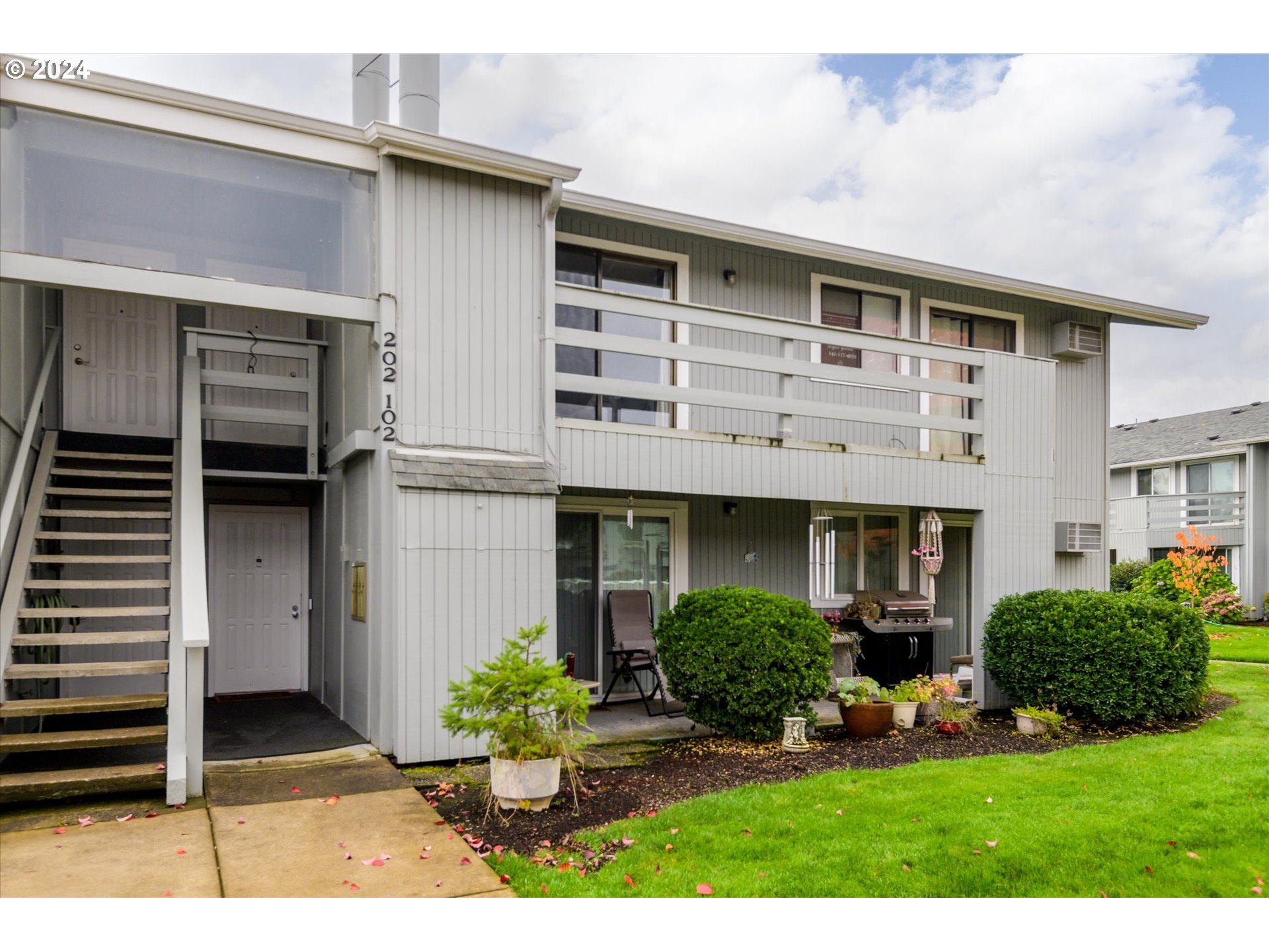 650 Harlow Road, Unit 202 Springfield, OR 97477 - Photo 1 of 34 a front view of a house with garden