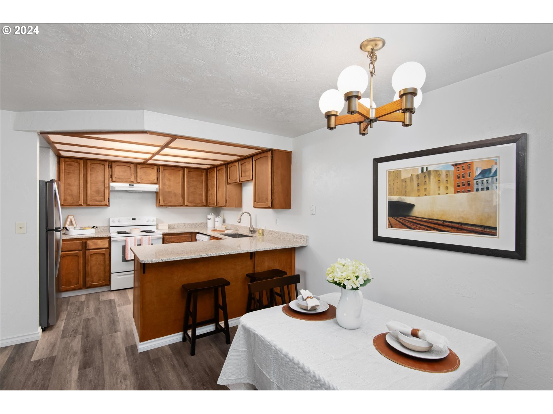 650 Harlow Road, Unit 202 Springfield, OR 97477 - Photo 9 of 34 a view of a dining room with furniture and chandelier