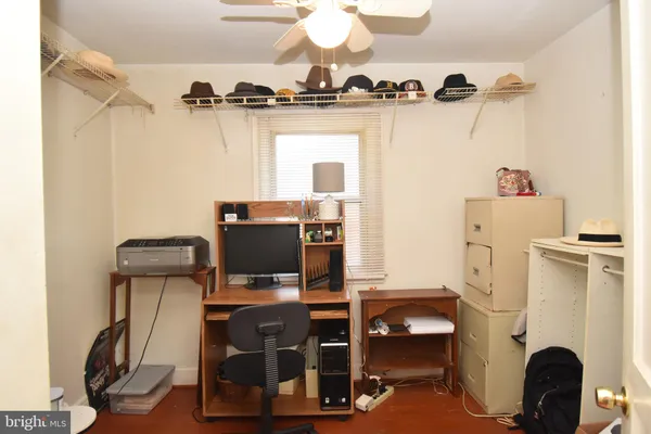 a view of a workspace with furniture and a flat screen tv