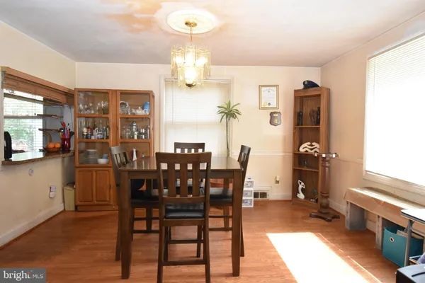 a view of a dining room with furniture and chandelier
