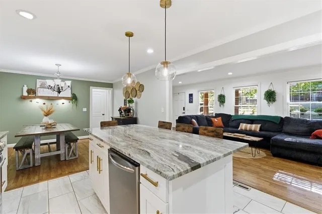 a view of a dining room with furniture a chandelier and wooden floor