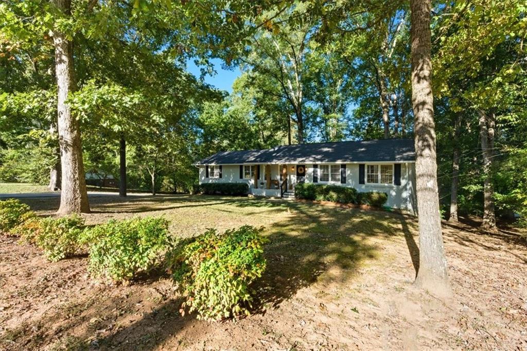 7 Thrushwood Road Northeast Rome, GA 30161 - Photo 47 of 52 a view of house with yard outdoor seating and covered with trees