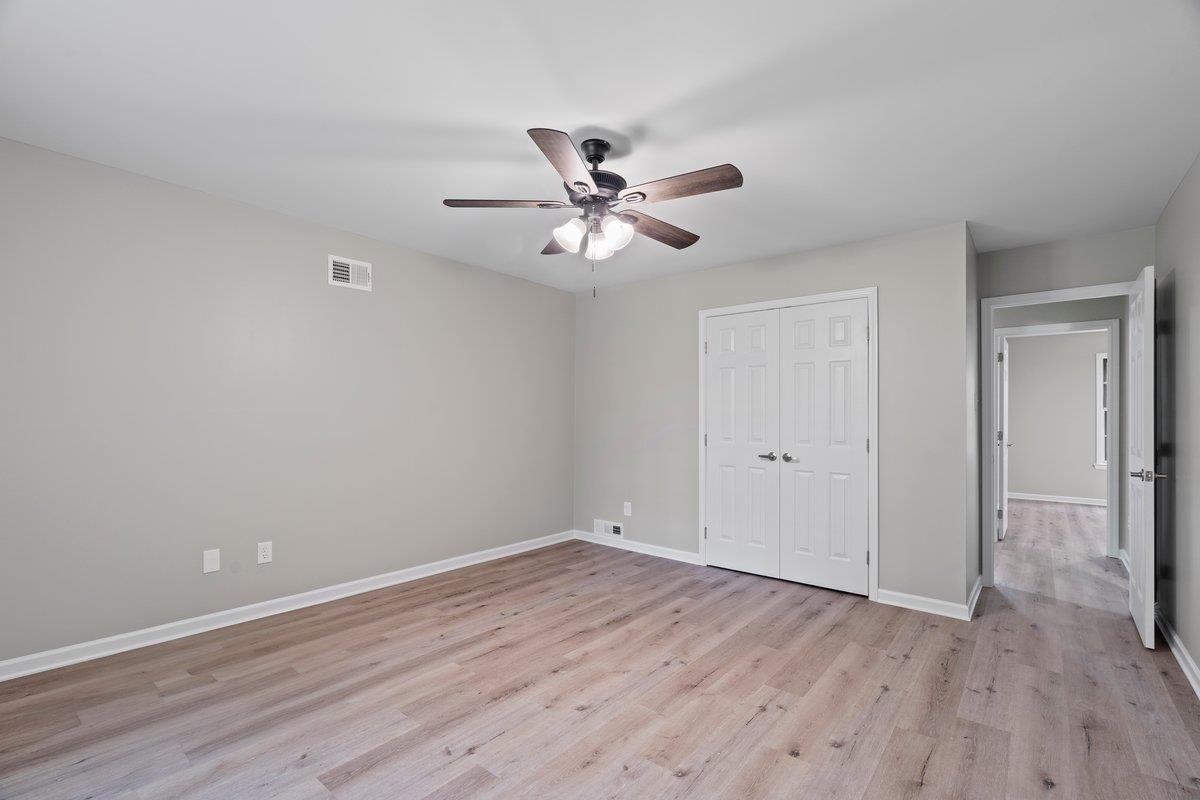 6410 Coteswood Road Memphis, TN 38134 - Photo 22 of 25 Unfurnished bedroom with light wood-style flooring, a closet, and baseboards