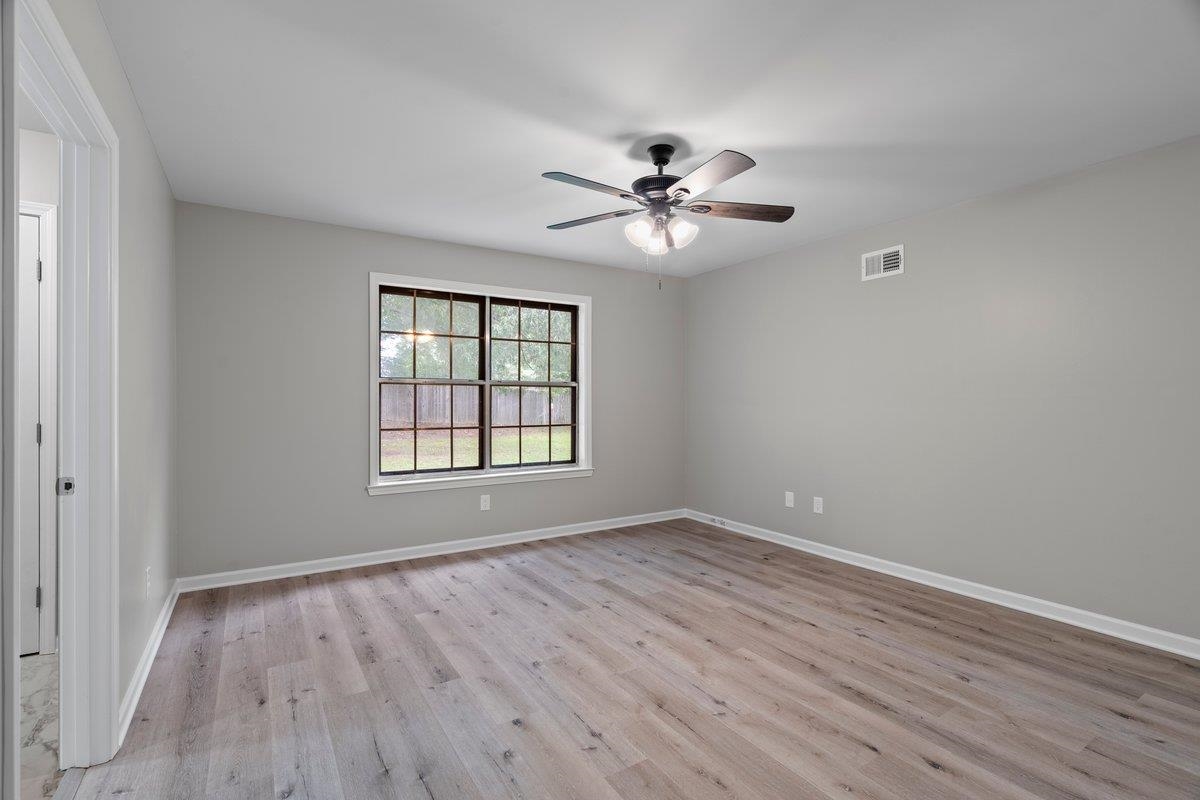 6410 Coteswood Road Memphis, TN 38134 - Photo 23 of 25 Unfurnished room featuring wood finished floors, baseboards, and ceiling fan