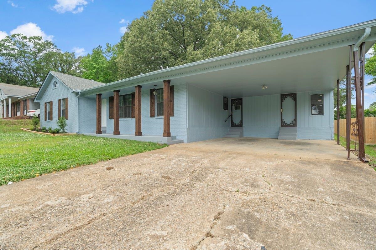 6410 Coteswood Road Memphis, TN 38134 - Photo 3 of 25 View of front facade with brick siding, an attached carport, and driveway