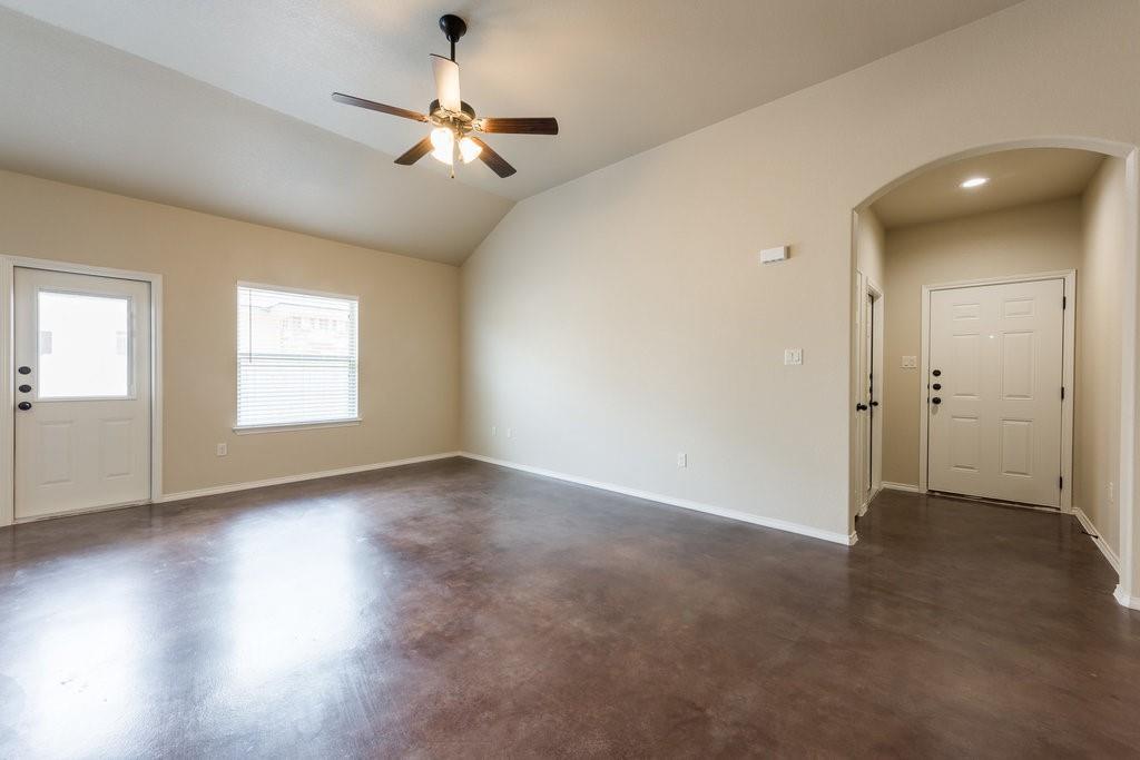 491 Jack Rabbit Lane, Unit A Buda, TX 78610 - Photo 7 of 22 A spacious living area with vaulted ceilings and durable concrete flooring awaits personalization.