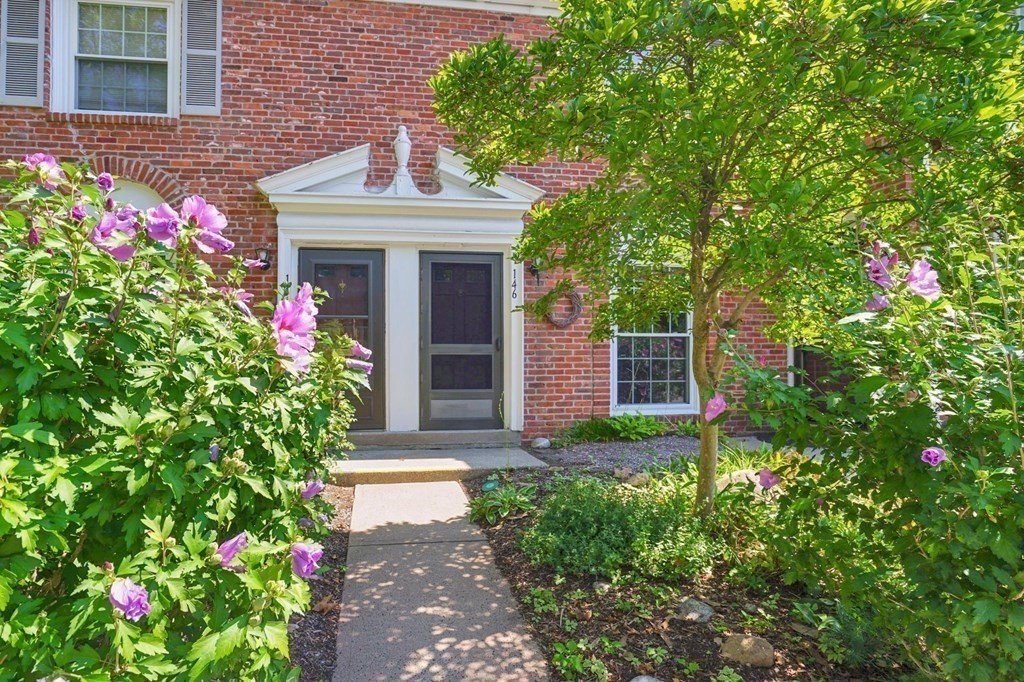 146 Jamestown Drive, Unit 146 Springfield, MA 01108 - Photo 1 of 26 a front view of a house with a yard