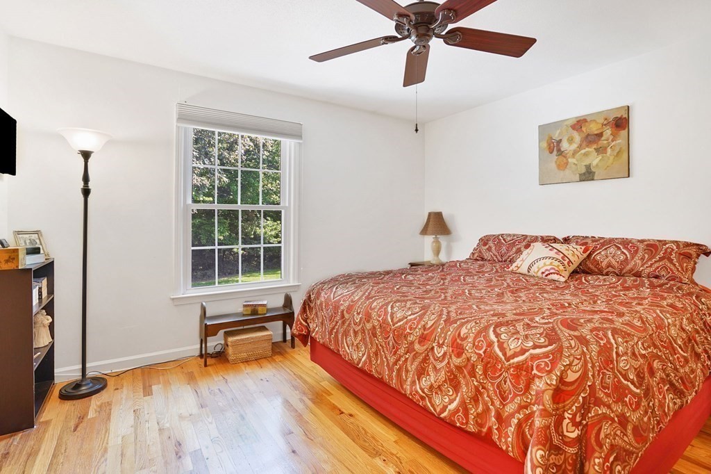 146 Jamestown Drive, Unit 146 Springfield, MA 01108 - Photo 18 of 26 a bedroom with a bed and wooden floor