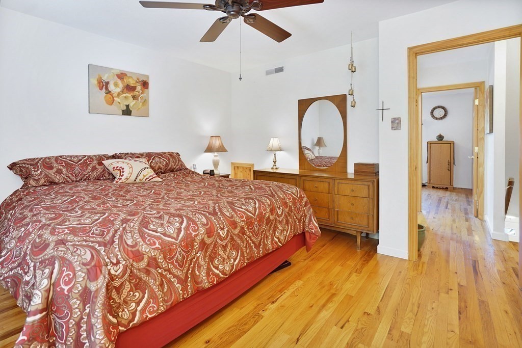 146 Jamestown Drive, Unit 146 Springfield, MA 01108 - Photo 19 of 26 a bed sitting in a bedroom next to a window