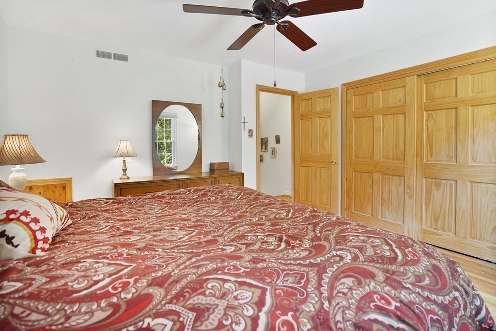 146 Jamestown Drive, Unit 146 Springfield, MA 01108 - Photo 20 of 26 a bedroom with a large bed and a chandelier