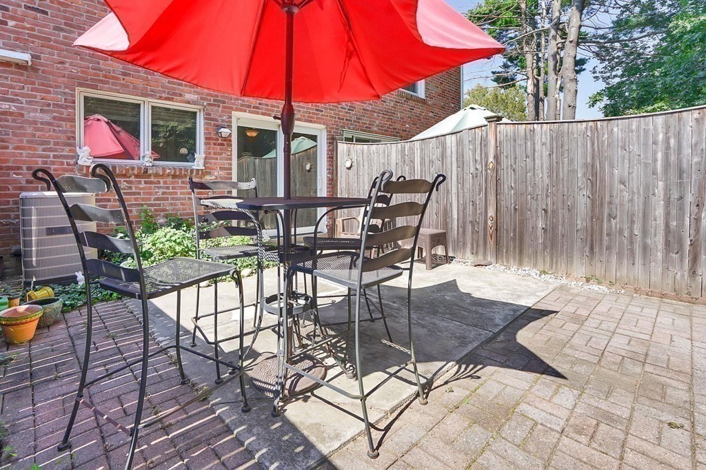 146 Jamestown Drive, Unit 146 Springfield, MA 01108 - Photo 2 of 26 a patio with glass top table and chairs