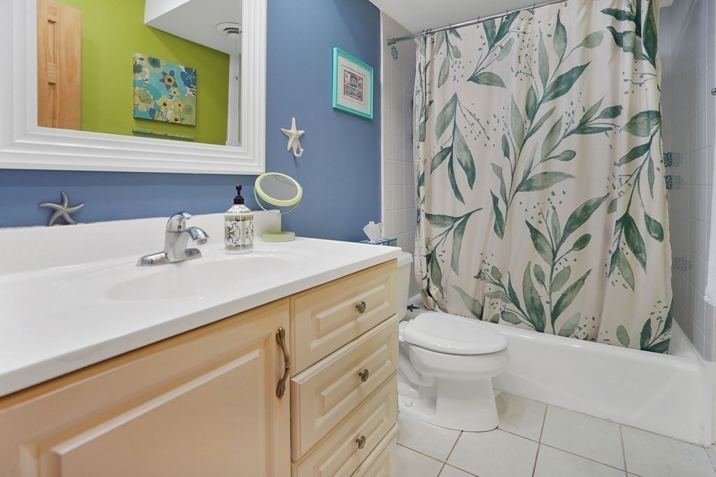 146 Jamestown Drive, Unit 146 Springfield, MA 01108 - Photo 21 of 26 a bathroom with a sink a toilet and a shower curtain