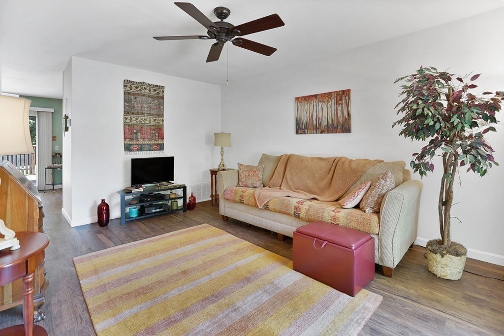 146 Jamestown Drive, Unit 146 Springfield, MA 01108 - Photo 7 of 26 a living room with furniture and a flat screen tv