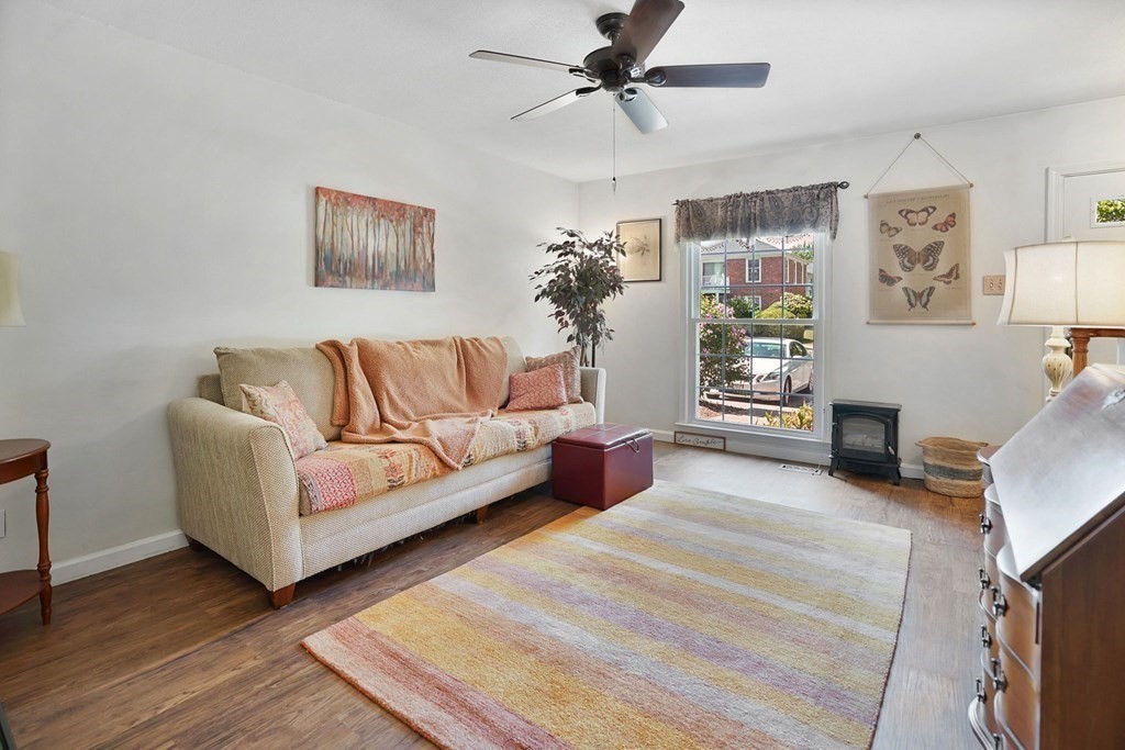 146 Jamestown Drive, Unit 146 Springfield, MA 01108 - Photo 8 of 26 a living room with furniture and a wooden floor
