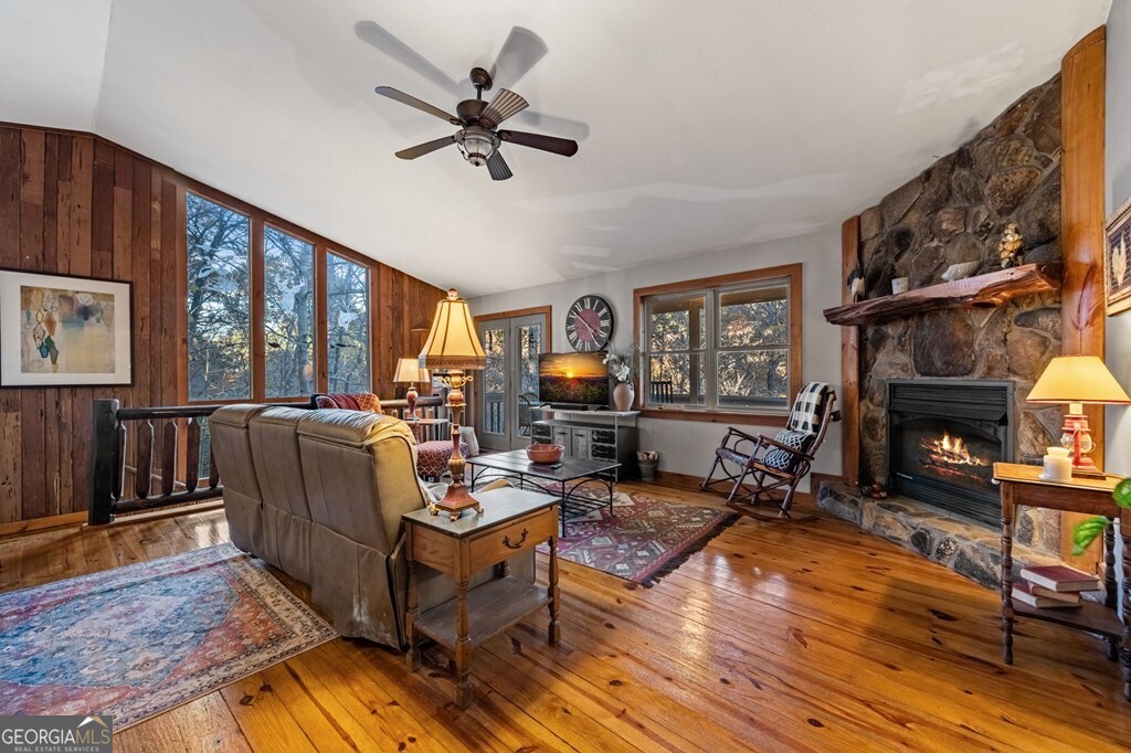 90 Hay Lane Morganton, GA 30560 - Photo 23 of 77 a living room with furniture a fireplace and a floor to ceiling window
