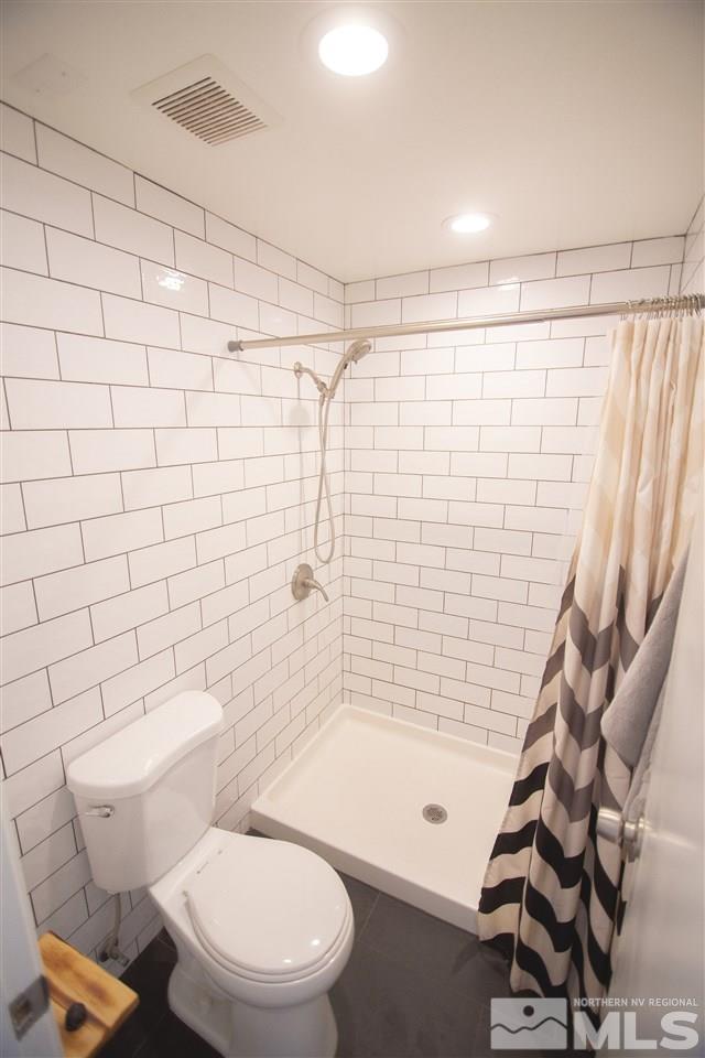 1960 Kings Row Reno, NV 89503 - Photo 11 of 16 a bathroom with a toilet and a shower