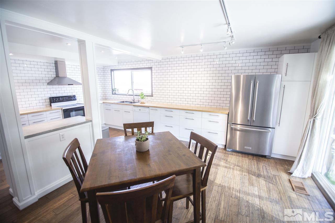 1960 Kings Row Reno, NV 89503 - Photo 6 of 16 a kitchen with stainless steel appliances granite countertop a dining table chairs and a refrigerator