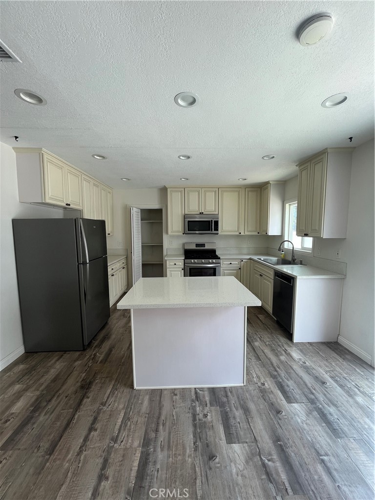3751 Briscoe Street Riverside, CA 92506 - Photo 11 of 16 a large kitchen with cabinets and stainless steel appliances