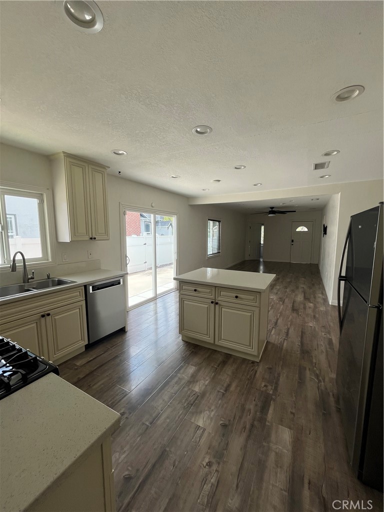 3751 Briscoe Street Riverside, CA 92506 - Photo 12 of 16 a large kitchen with stainless steel appliances a large counter top a stove a sink a refrigerator and cabinets