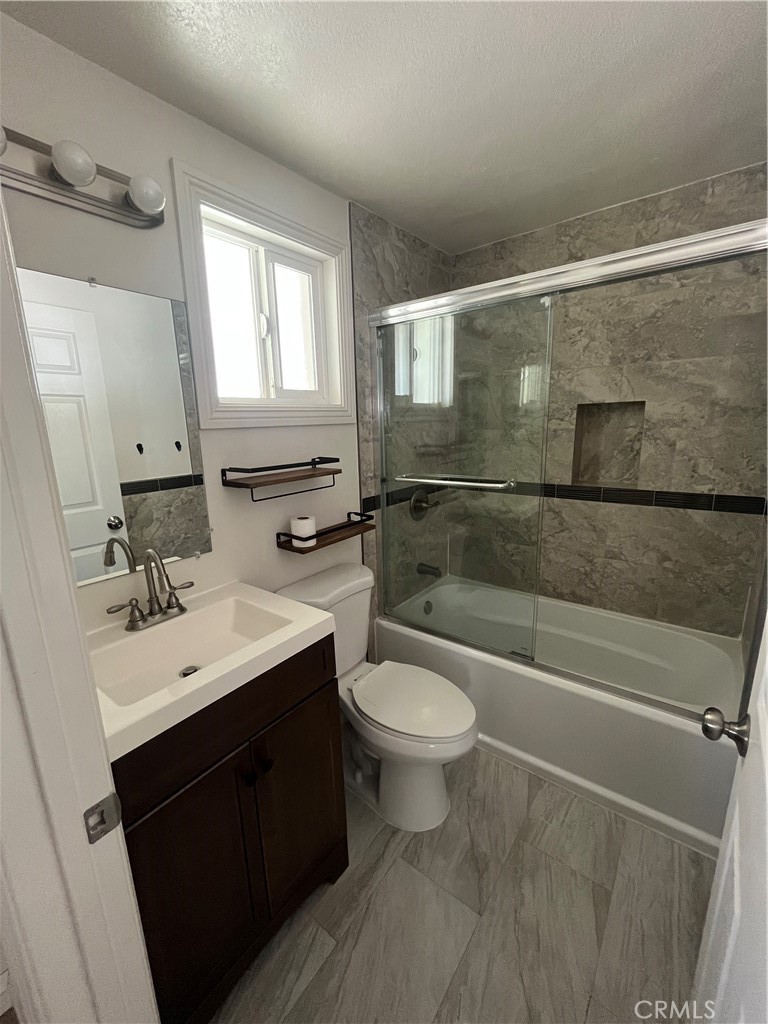 3751 Briscoe Street Riverside, CA 92506 - Photo 16 of 16 a bathroom with a sink toilet a mirror and bathtub