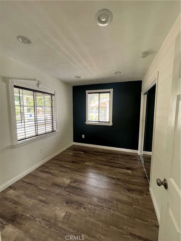 3751 Briscoe Street Riverside, CA 92506 - Photo 8 of 16 a view of an empty room with a window and wooden floor