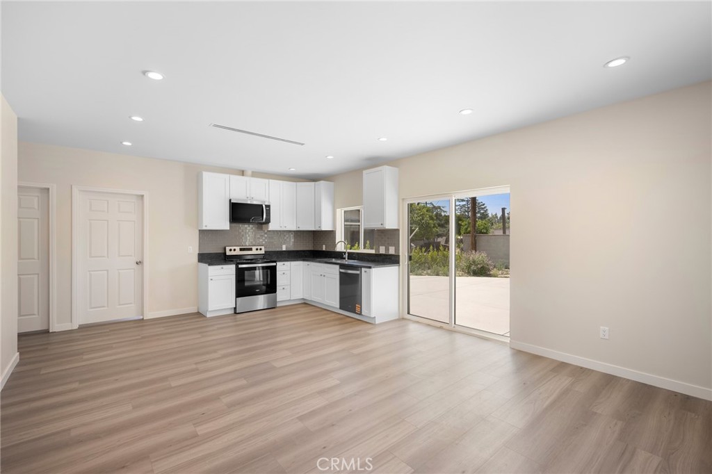 8435 Rincon Avenue Sun Valley, CA 91352 - Photo 40 of 61 a large kitchen with stainless steel appliances granite countertop a stove and a wooden floors