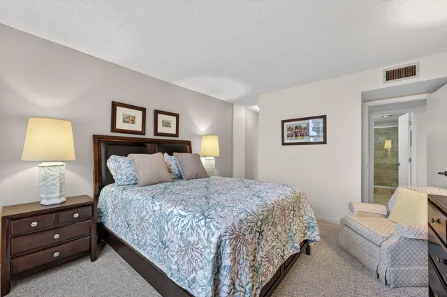 a bedroom with a bed and a lamp on table