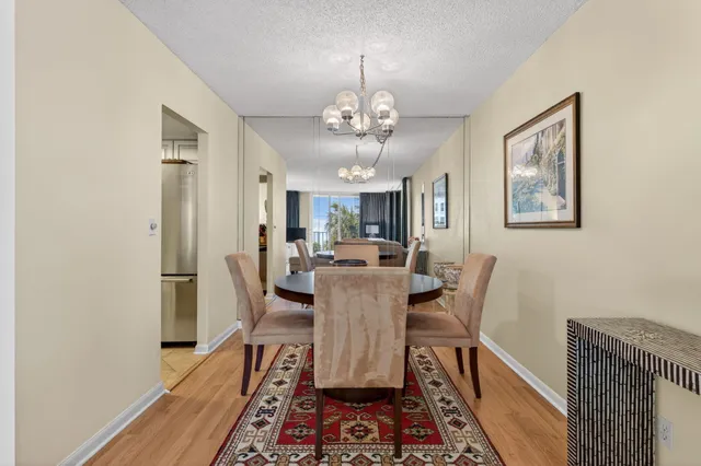 a dining room with furniture a rug and wooden floor