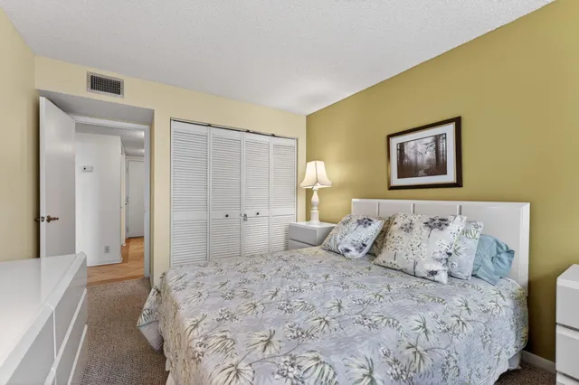 a bedroom with a bed and a painting on the wall