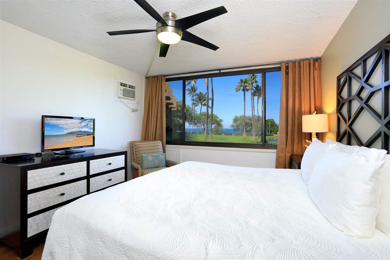 2695 South Kihei Road, Unit 10115 Kihei, HI 96753 - Photo 11 of 28 a bedroom with a bed and a flat screen tv