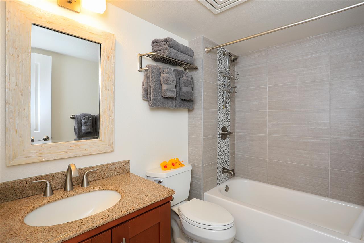 2695 South Kihei Road, Unit 10115 Kihei, HI 96753 - Photo 16 of 28 a bathroom with a granite countertop sink toilet a mirror and shower