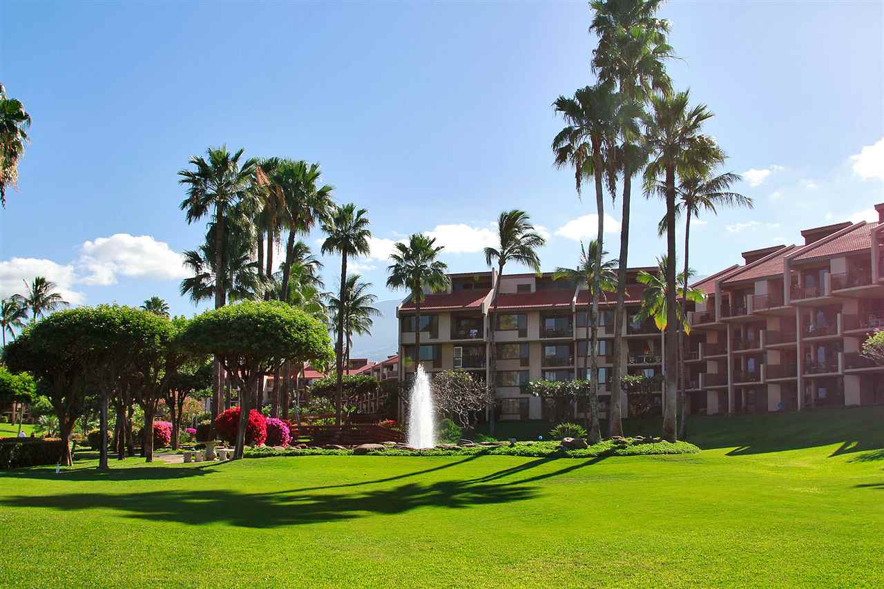 2695 South Kihei Road, Unit 10115 Kihei, HI 96753 - Photo 23 of 28 a front view of multi story residential apartment building with yard and green space