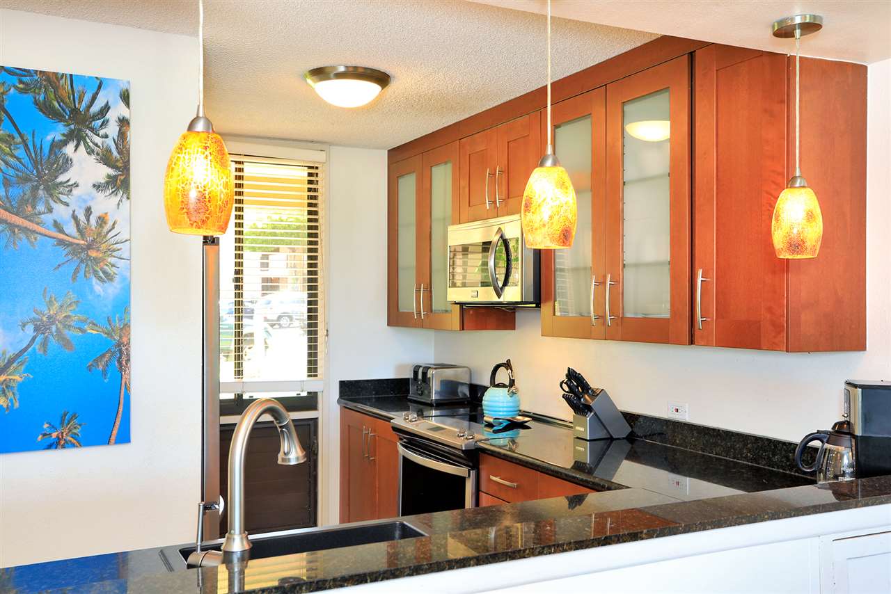2695 South Kihei Road, Unit 10115 Kihei, HI 96753 - Photo 3 of 28 a kitchen with a window a sink and a counter top space