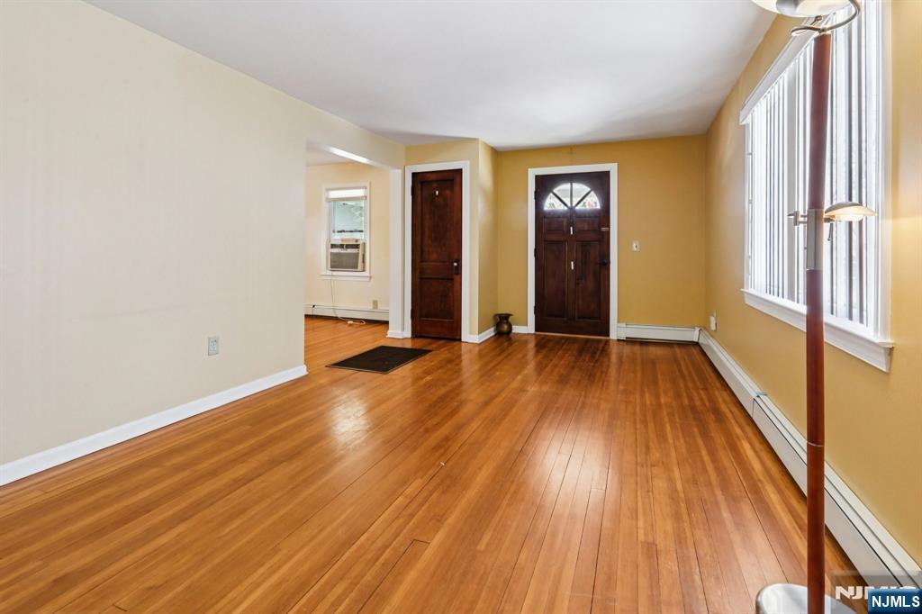 63 West Airmount Road Mahwah, NJ 07430 - Photo 5 of 20 a view of an empty room with window and wooden floor