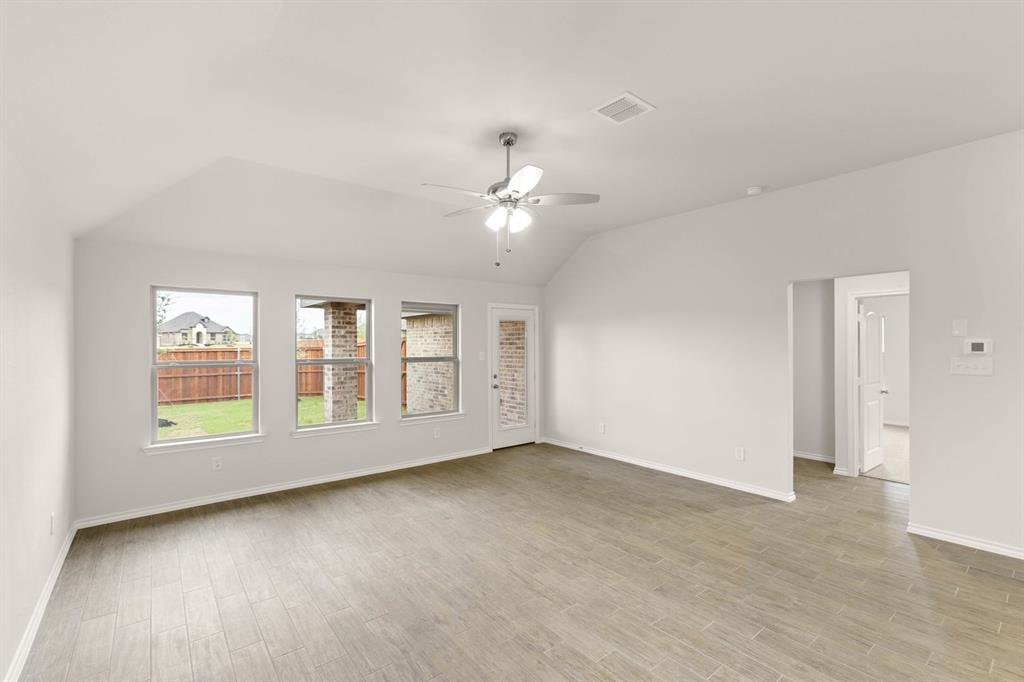 2841 Hay Lane Midlothian, TX 76065 - Photo 12 of 27 an empty room with chandelier fan and windows