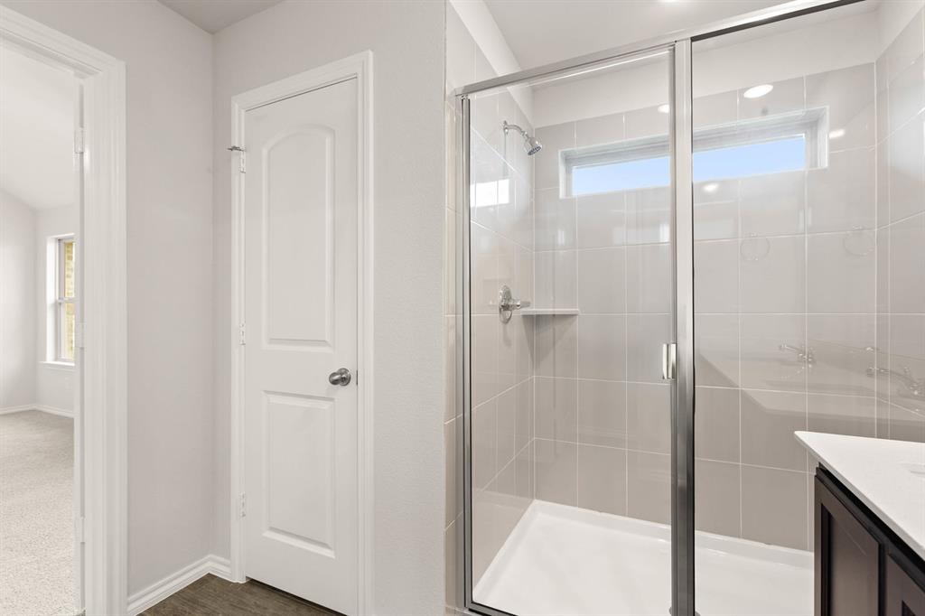 2841 Hay Lane Midlothian, TX 76065 - Photo 23 of 27 a bathroom with a glass shower door