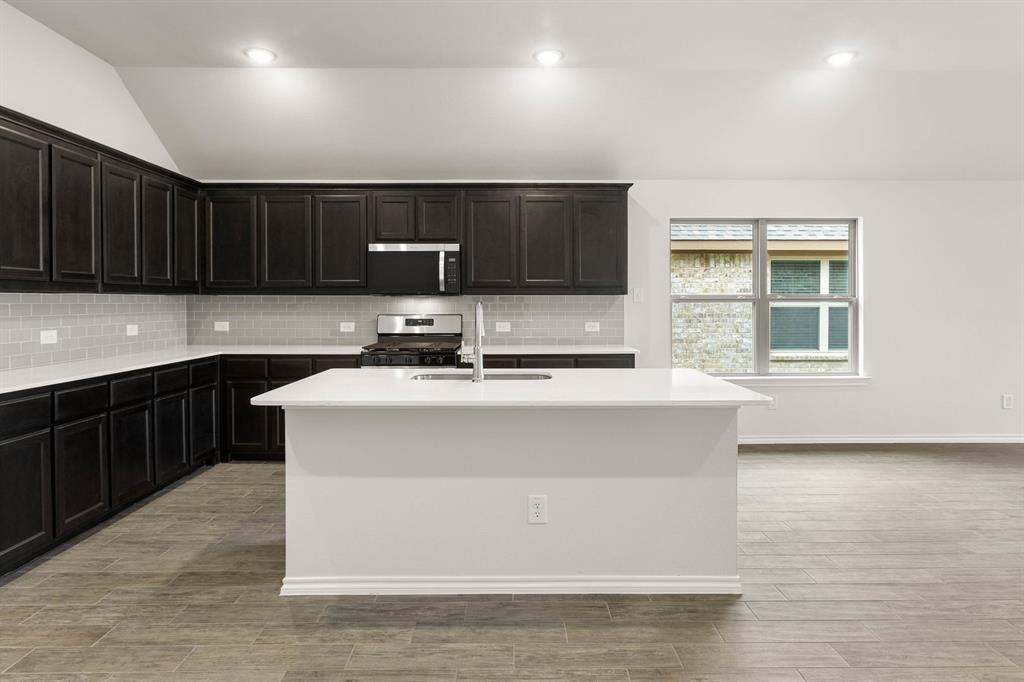 2841 Hay Lane Midlothian, TX 76065 - Photo 5 of 27 a kitchen with kitchen island a sink stainless steel appliances and cabinets