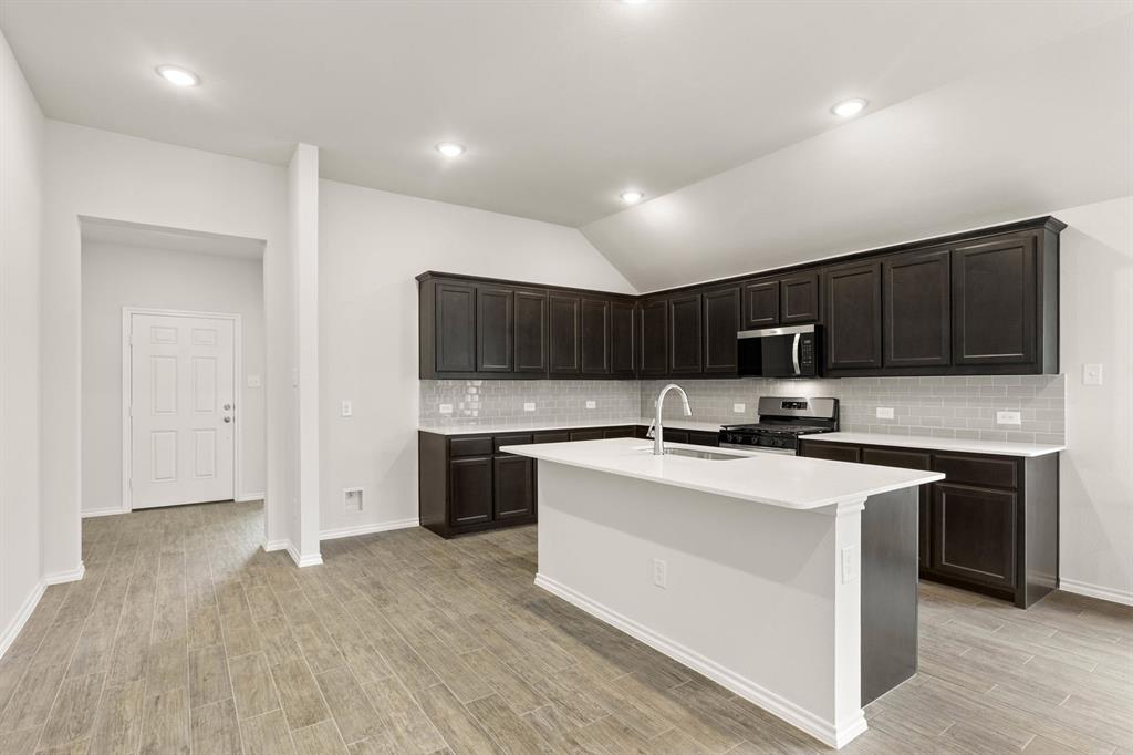 2841 Hay Lane Midlothian, TX 76065 - Photo 6 of 27 a kitchen with stainless steel appliances a stove top oven a sink a refrigerator and cabinets