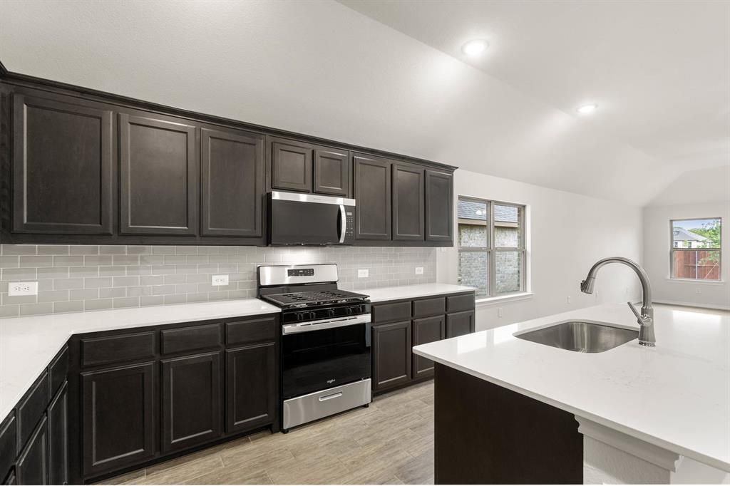 2841 Hay Lane Midlothian, TX 76065 - Photo 7 of 27 a kitchen with sink a microwave and cabinets
