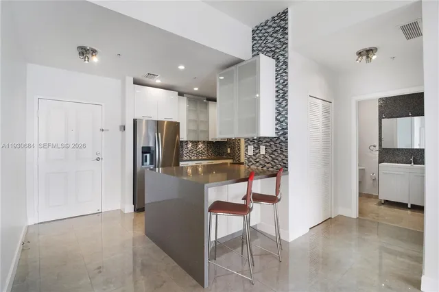 a kitchen with stainless steel appliances a refrigerator and a stove top oven
