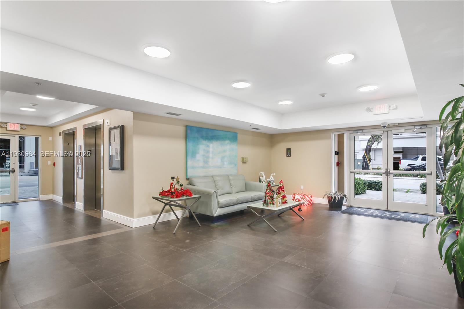 2650 Southwest 37th Avenue, Unit 901 Miami, FL 33134 - Photo 26 of 31 a living room with furniture and wooden floor