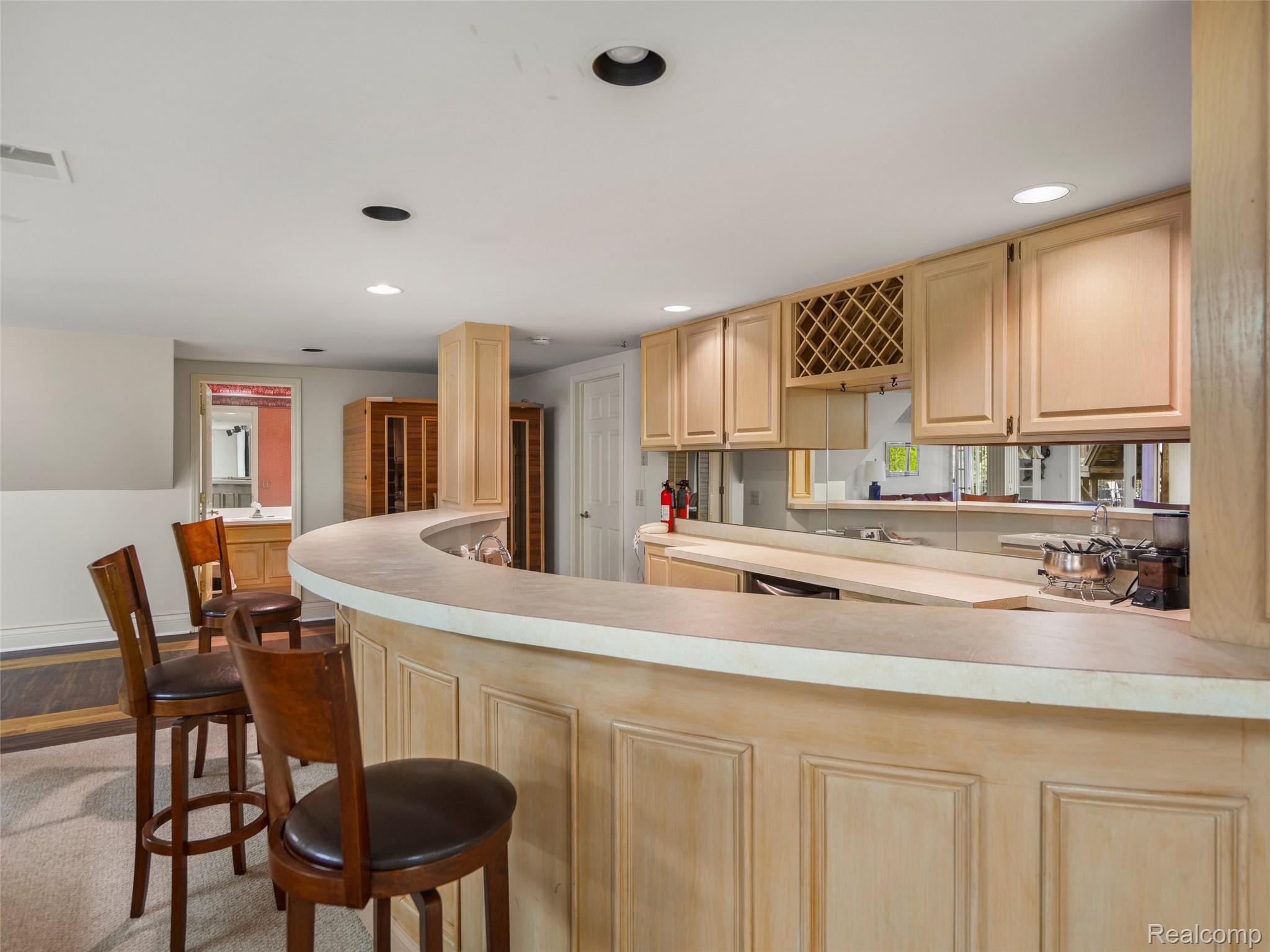 5724 Murfield Drive Rochester, MI 48306 - Photo 97 of 99 Kitchen featuring a peninsula, light countertops, recessed lighting, light brown cabinets, and a kitchen breakfast bar